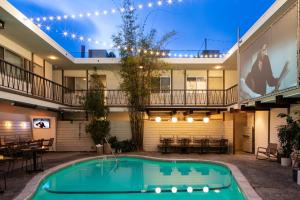 a swimming pool in the courtyard of a building with a house at The Pearl Hotel in San Diego