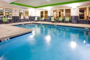 a large swimming pool with blue water in a building at Holiday Inn Express Hotel & Suites Newport South, an IHG Hotel in Newport