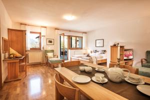 a kitchen and living room with a table and chairs at Residence Landhaus Fux in Silandro