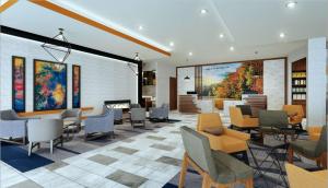 vestíbulo con sillas, mesas y chimenea en La Quinta Inn & Suites by Wyndham-Albany GA, en Albany