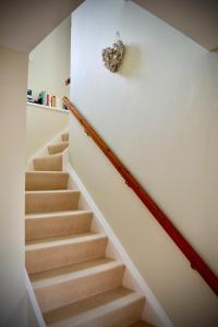 a staircase in a house with a stair case at Peaceful 2 bedroom granite country dower house in La Villaise