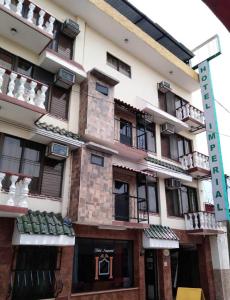 a building with a street sign in front of it at Hotel Imperial Jojutla in Jojutla de Ju&aacute;rez
