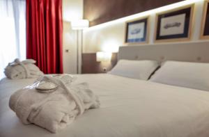 a hotel room with a bed with towels on it at Best Western Plus Hotel Modena Resort in Formigine