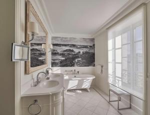 une salle de bain blanche avec une baignoire et un lavabo dans l'établissement Hôtel du Palais Biarritz, in The Unbound Collection by Hyatt, à Biarritz