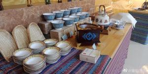 a table with a bunch of blue and white plates at KaoShan Tent Zhangye in Zhangye