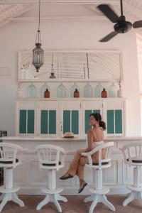 a woman sitting on a chair in a room at Tamarind Hill by Asia Leisure in Galle