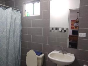 a bathroom with a toilet and a sink at Departamento UNIVERSITARIO en fraccionamiento privado in Chihuahua