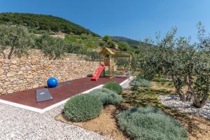 a garden with a playground with a swing at Villa Blue Sky in Bol