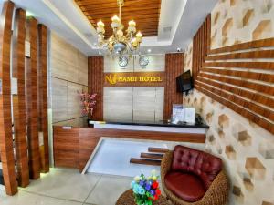 a lobby of a hotel with a chair and a desk at Namii Hotel in Nagoya