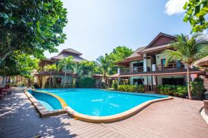 a swimming pool in front of a house at Nice Beach Resort Koh Pha-ngan in Thong Nai Pan Yai