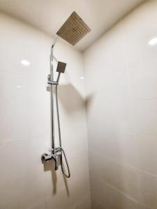 a shower in a bathroom with a shower head at Namii Hotel in Nagoya
