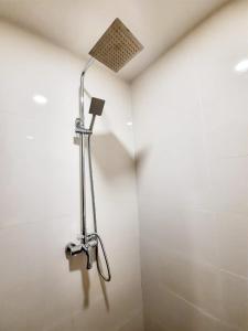 a shower in a bathroom with a shower head at Namii Hotel in Nagoya +24 photos