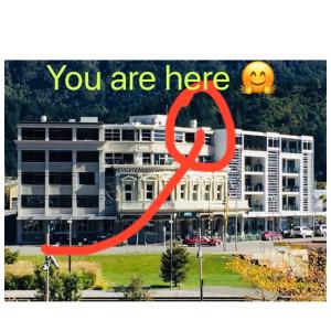a sign that says you are here in front of a building at Astonishing Views Superb Waterfront Apartment in Picton