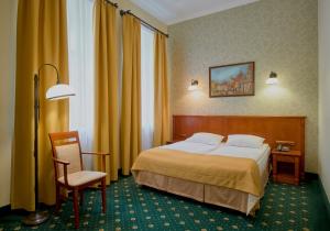 a hotel room with a bed and a desk at Hotel Hetman in Warsaw