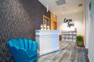a salon with a blue chair and a law spa sign at Hotel Lava Beach in Puerto del Carmen