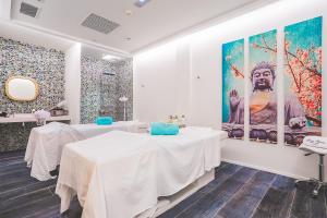 a room with two tables and a large painting on the wall at Hotel Lava Beach in Puerto del Carmen