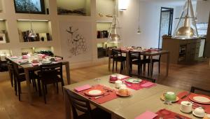 a dining room with tables and chairs with pink napkins at Locanda Palazzone in Orvieto