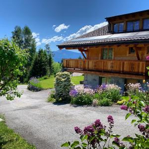 a house with flowers in front of it at Chalet La Renarde in Villars-sur-Ollon