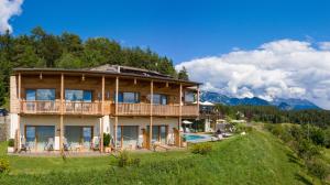 a house on a hill with a swimming pool at Hotel am Hang in Soprabolzano