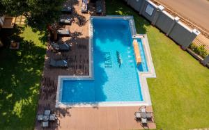 an overhead view of a swimming pool with grass at Kilimanjaro Wonders Hotel in Moshi