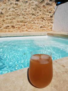 a drink in a glass next to a swimming pool at Ca Na Marreta in Porreres