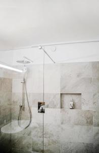 a shower with a glass door in a bathroom at Hotel am Hang in Soprabolzano