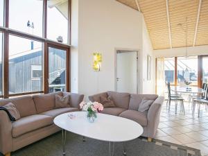een woonkamer met een bank en een tafel bij 8 person holiday home in Ulfborg in Thorsminde