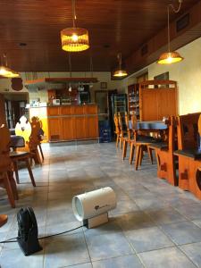 a dining room with a table and chairs and a fan at Hotel Sirákov in Liptál