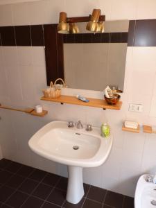 a bathroom with a sink and a mirror at Villa degli Scoiattoli in SantʼElpidio a Mare