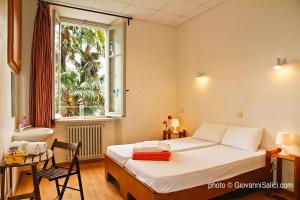 A bed or beds in a room at SANTANGELA Hostel & Rooms
