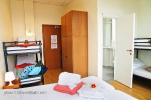 A bed or beds in a room at SANTANGELA Hostel & Rooms