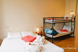 A bed or beds in a room at SANTANGELA Hostel & Rooms