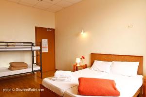 A bed or beds in a room at SANTANGELA Hostel & Rooms