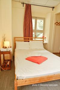 A bed or beds in a room at SANTANGELA Hostel & Rooms