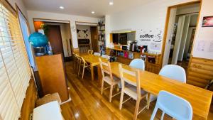 a dining room with a wooden table and chairs at 2nd House in Kitashiobara