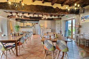 cocina y comedor con mesas y sillas de madera en Chambres D'HÔTES en Vezin-le-Coquet