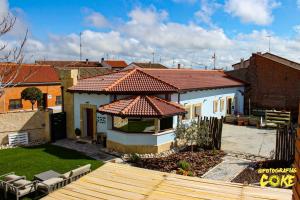 a house with a tile roof on a yard at Las Gavias in Matapozuelos