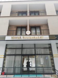 a building with a sign that reads hotel synergy ash at Hotel Sultansaray Sultanhanı in Sultanhanı