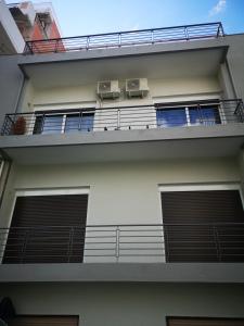 an apartment building with two air conditioners on the balcony at Explore Greece from Cozy City Centre Apartment in Chalkida