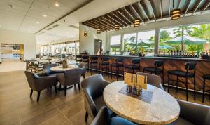 a restaurant with tables and chairs and a bar at Hyatt Place Orlando/Lake Buena Vista in Orlando