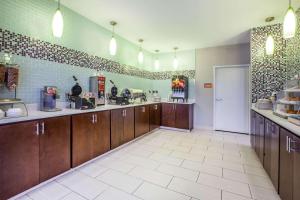 duża kuchnia z brązowymi szafkami i białą podłogą wyłożoną kafelkami w obiekcie La Quinta Inn and Suites by Wyndham Elkhart w mieście Elkhart
