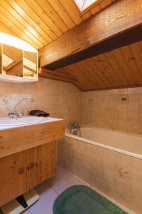 a bathroom with a sink and a bath tub at L'arpont in Champagny-en-Vanoise