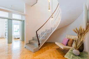 a living room with a staircase and a couch at INCREDIBLE DUPLEX PENTHOUSE & TERRACES & Parking in Porto