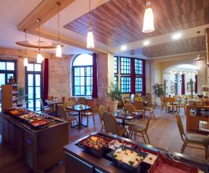 a dining room filled with tables and chairs at New Imperial Hotel in Jerusalem