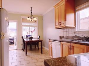 a kitchen with a table and a dining room at Lisa’s lovely little house in Vancouver