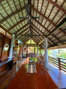 a living room with a ceiling fan and a table at Langit Rimba Resort in Seremban