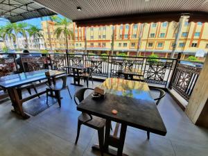a restaurant with tables and chairs on a balcony at Namii Hotel in Nagoya