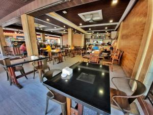 a restaurant with tables and chairs and people in the background at Namii Hotel in Nagoya