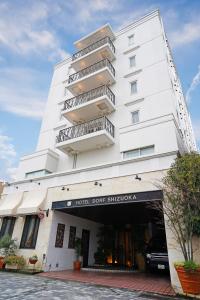 a white building with balconies on the side of it at Hotel Dorf Shizuoka in Shizuoka