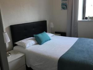 - une chambre avec un lit doté d'un oreiller bleu dans l'établissement A coté de Genève 2, à Saint-Cergues